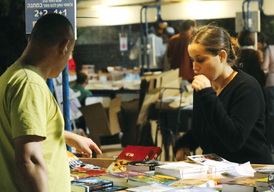 People purchase books at the annual book fair in Jerusalem