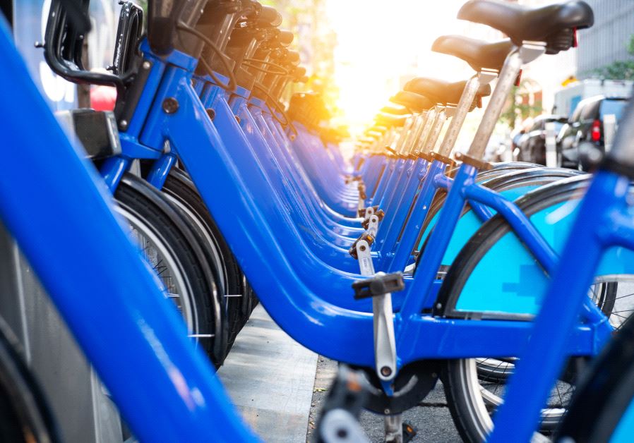 Bicycle rental service spot on city street. Public transportation concept.