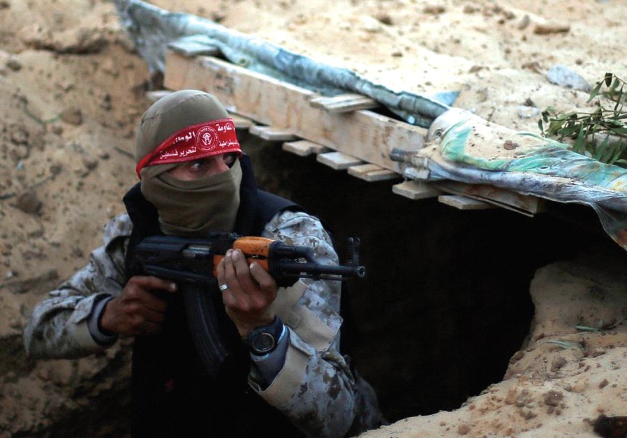 A hamas militant takes part in a tunnel attack simulation during a graduation ceremony in Rafah, in the southern Gaza Strip, last November