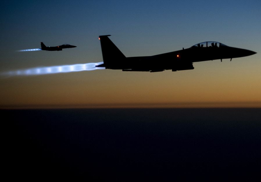 A pair of US Air Force F-15E Strike Eagles fly over northern Iraq after conducting airstrikes in Syria