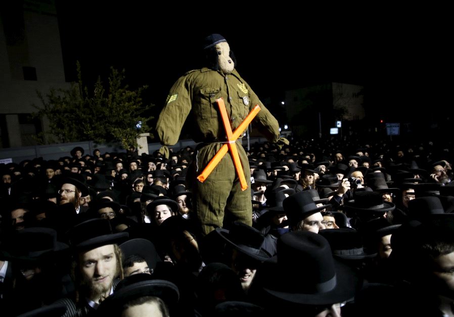 Ultra-Orthodox Jews attend a protest against a law calling for members of their community to serve in the army, in Jerusalem's Mea Shearim neighbourhood December 22, 2015.