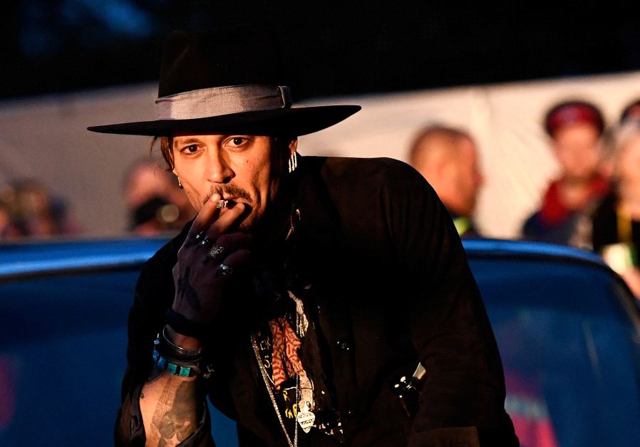 Actor Johnny Depp poses on a Cadillac before presenting his film The Libertine, at Cinemageddon at Worthy Farm in Somerset during the Glastonbury Festival in Britain, June 22, 2017.