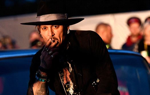 Actor Johnny Depp poses on a Cadillac before presenting his film The Libertine, at Cinemageddon at Worthy Farm in Somerset during the Glastonbury Festival in Britain, June 22, 2017.
