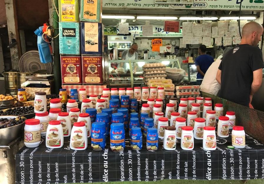  Karawan tahini (the blue jar) being sold alongside Al Arz tahini from Nazareth, and Yona tahini from Nablus at Tel Aviv's Carmel Market, May 19, 2017