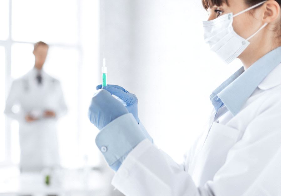 Close up of female doctor holding syringe with injection (iilustrative)
