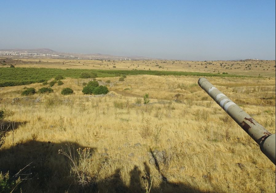 An old IDF tank barrel from the Yom Kippur War looks out over the Syrian side of the Golan from a hilltop a few hundred meters from the border