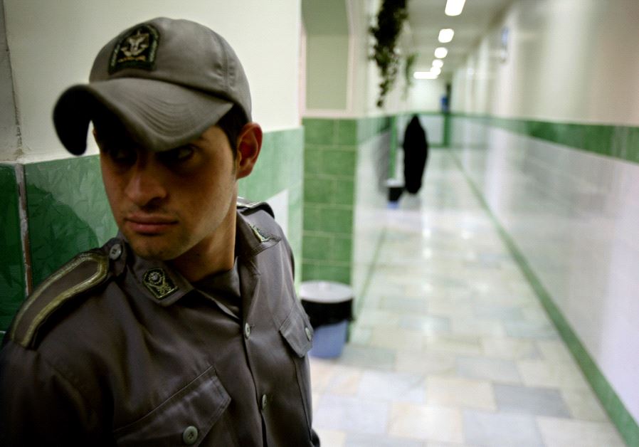 A prison guard stands along a corridor in Tehran's Evin prison June 13, 2006. 