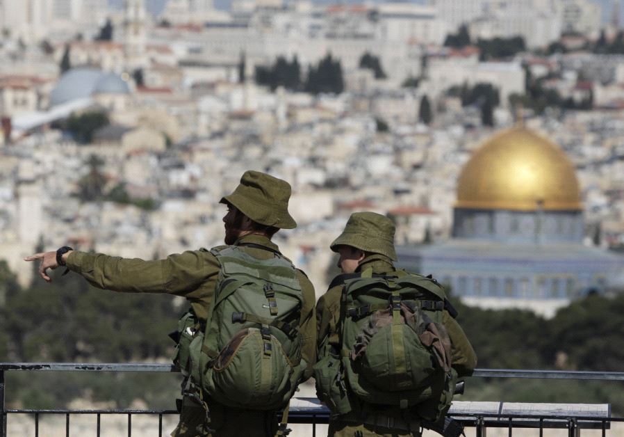 IDF soldiers stand at a lookout point on the Mount of Olives, overlooking the Dome of the Rock in Jerusalem's Old City