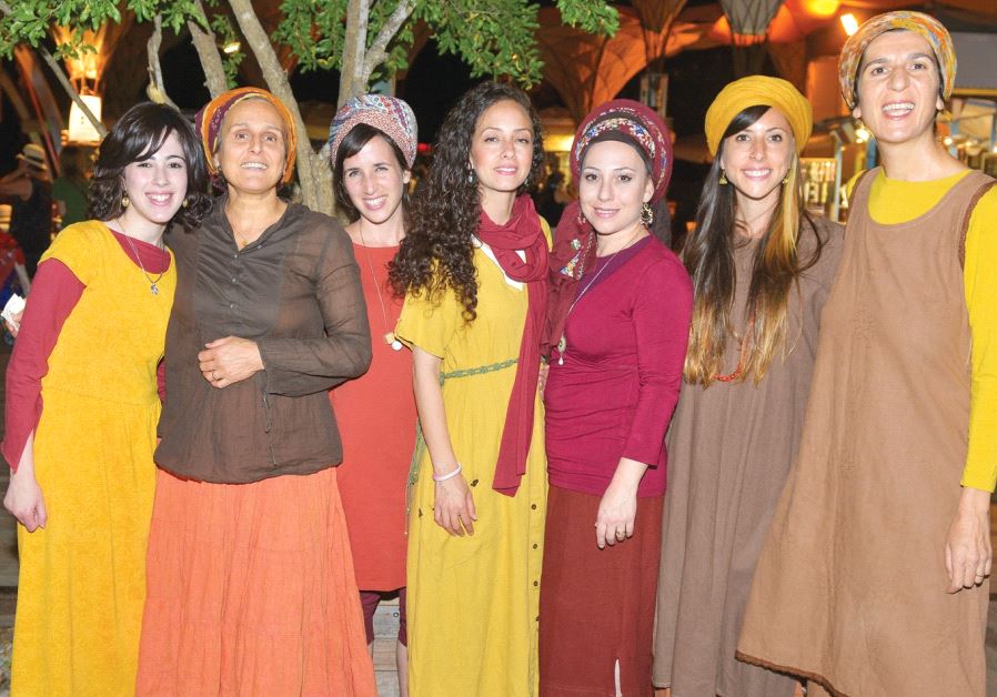 Spotlight artist Ana Elya (second from left), who sings as well as plays guitar and drums, with the Adamama choir