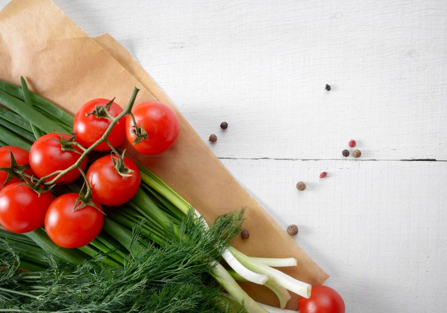 Fresh organic vegetable set of tomatoes dill and onion on white kitchen table