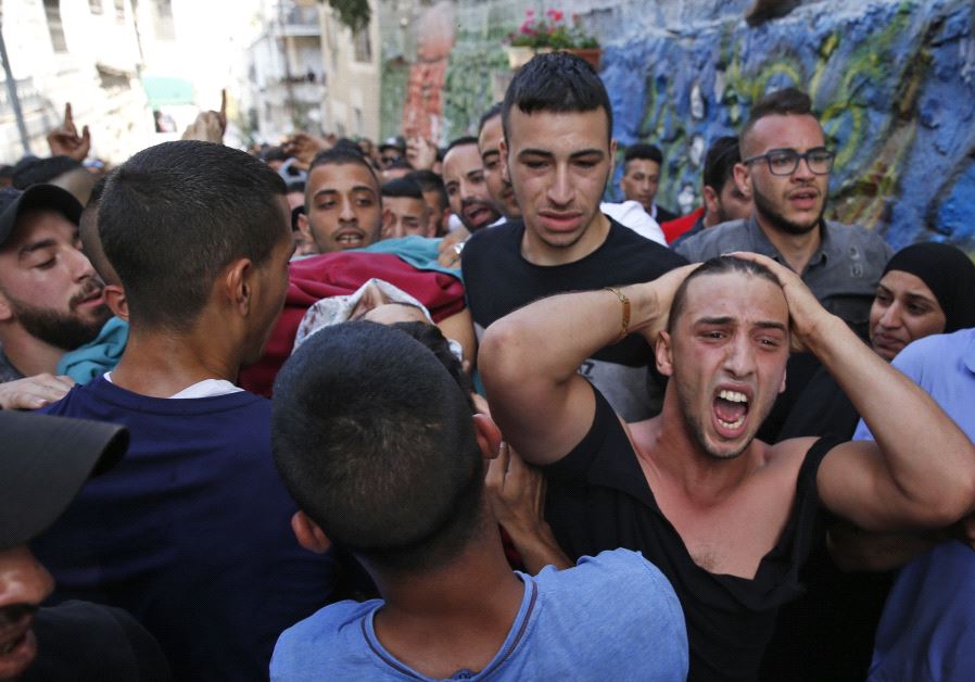 Palestinian relatives of Mohammed Abu Ghannam, who was shot dead during clashes with Israeli forces, mourn during his funeral in the A-Tur area of east Jerusalem, on July 21, 2017.