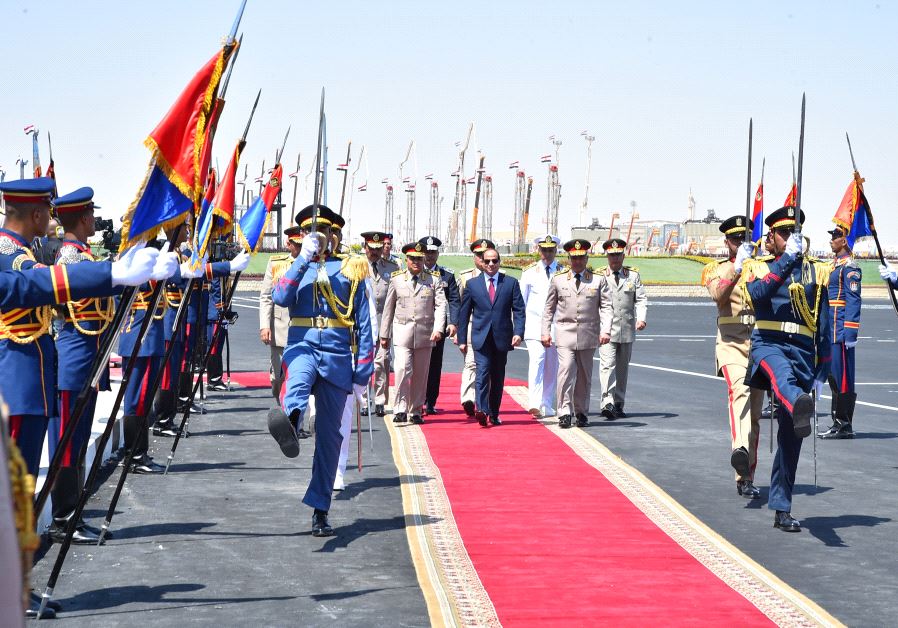 Egyptian President Abdel Fattah al-Sisi (C) arrives at the opening of the Mohamed Najib military base